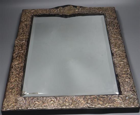 A large repousse sterling mounted easel mirror, overall height 56.3cm.